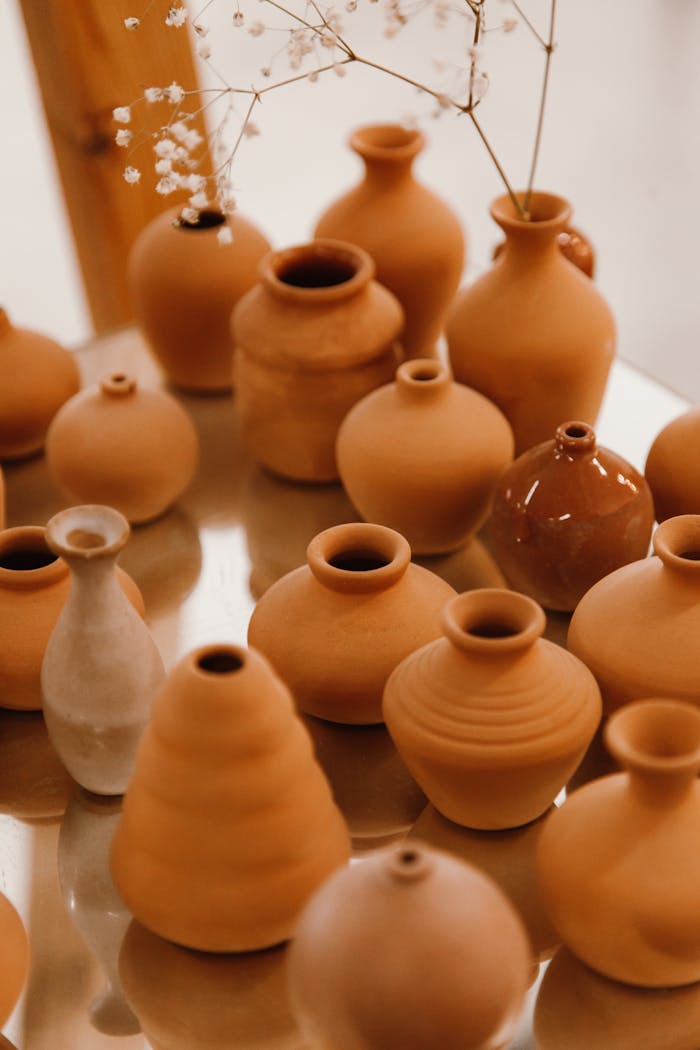 A variety of handcrafted clay pots and vases arranged elegantly.